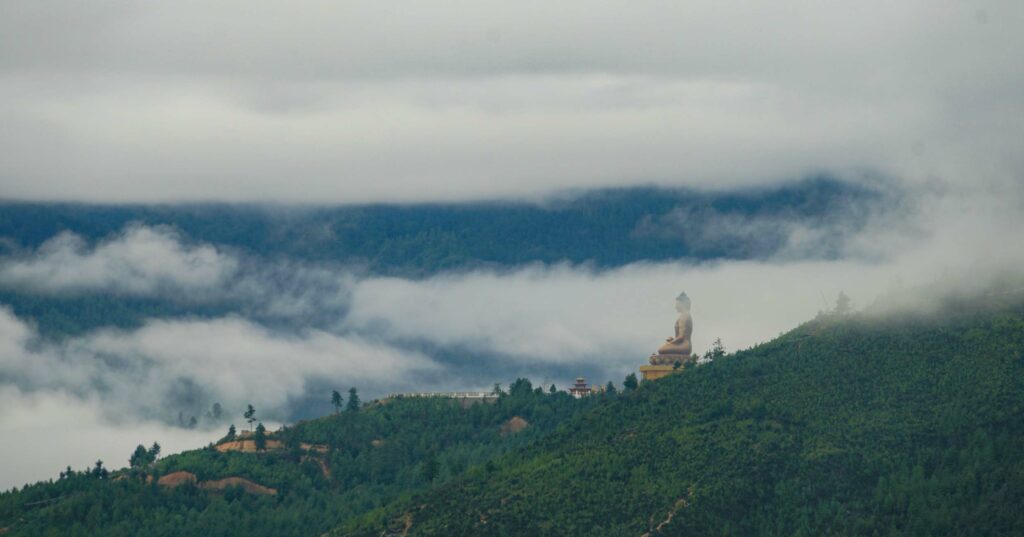 distant view of the statue of buddha in bhutan